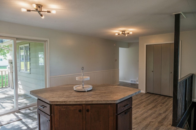 600 Venn St, Sherburn, MN 56171 - kitchen with wainscoting, dark wood finished floors, and a center island
