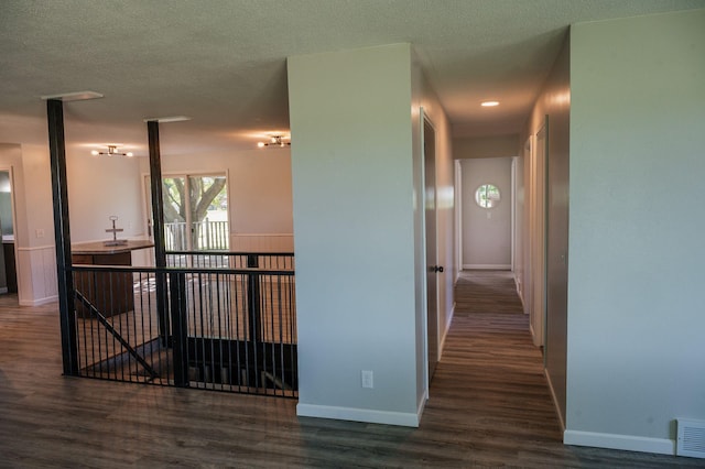 600 Venn St, Sherburn, MN 56171 - hallway with wood finished floors and a textured ceiling