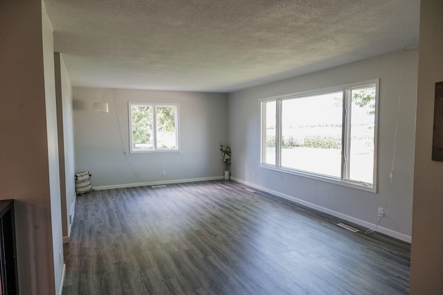 600 Venn St, Sherburn, MN 56171 - unfurnished room featuring dark wood-style floors and a textured ceiling