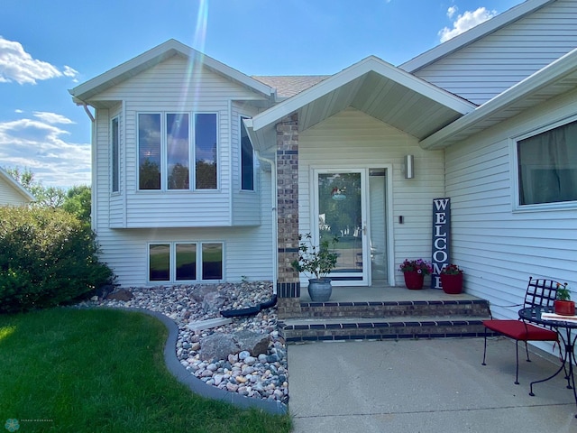 1506 Woodridge Ln, West Fargo, ND 58078 - entrance to property with a patio area and stone siding