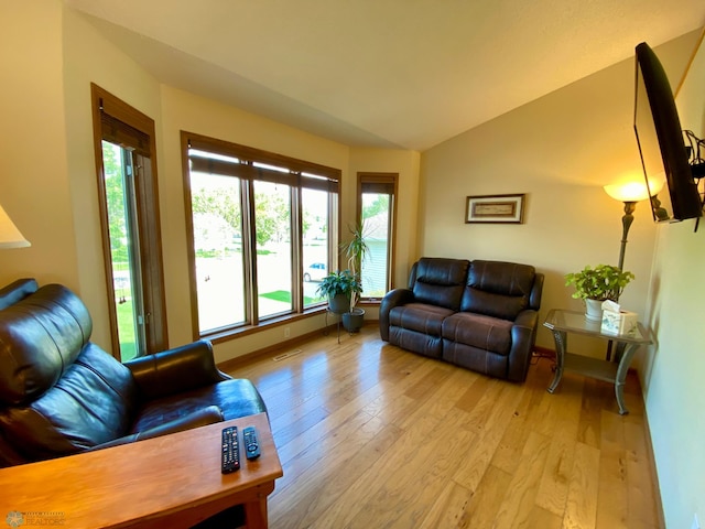 1506 Woodridge Ln, West Fargo, ND 58078 - living area featuring light wood-style floors and vaulted ceiling