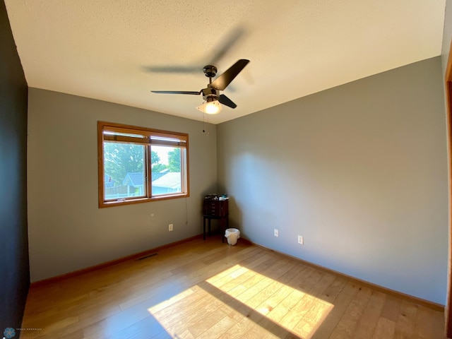 1506 Woodridge Ln, West Fargo, ND 58078 - empty room with light wood-style floors and a ceiling fan