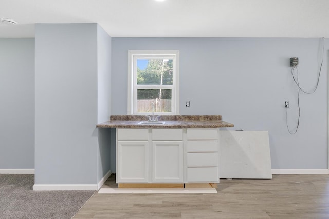 605 Central Ave SW, Cambridge, MN 55008 - kitchen with white cabinetry and light wood finished floors