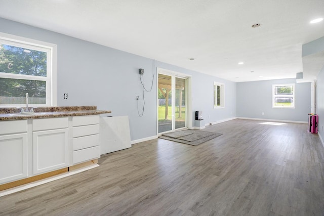 605 Central Ave SW, Cambridge, MN 55008 - kitchen with white cabinets, light wood-style flooring, open floor plan, and recessed lighting