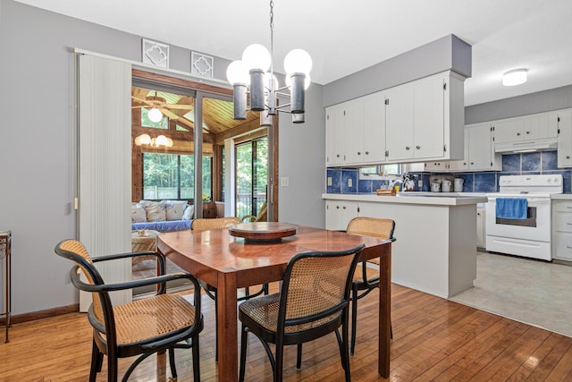 6670 Maple Dr, Rockford, MN 55373 - dining area with light wood-type flooring and a chandelier