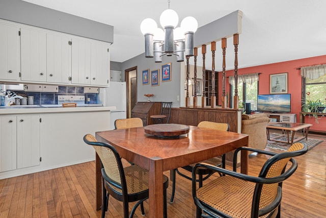6670 Maple Dr, Rockford, MN 55373 - dining room with a chandelier and light wood finished floors