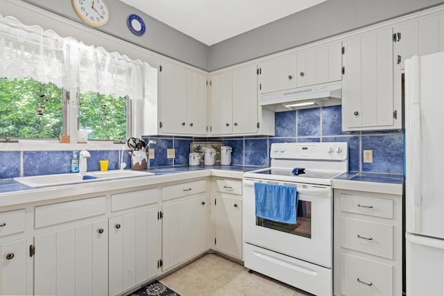 6670 Maple Dr, Rockford, MN 55373 - kitchen with white appliances, under cabinet range hood, backsplash, white cabinets, and light tile patterned flooring