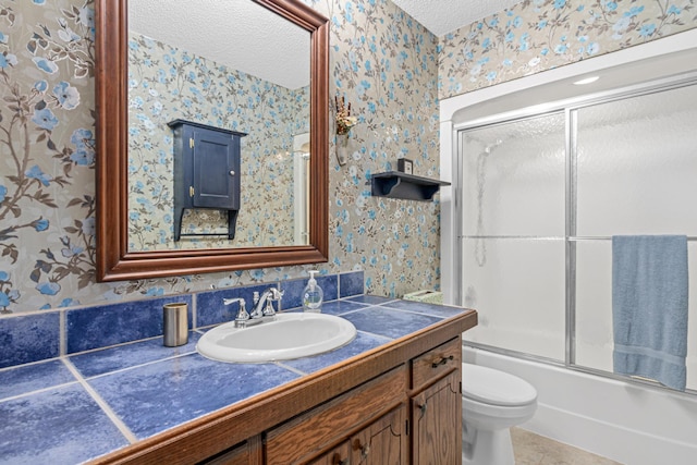 6670 Maple Dr, Rockford, MN 55373 - bathroom with wallpapered walls, a textured ceiling, vanity, enclosed tub / shower combo, and tile patterned flooring