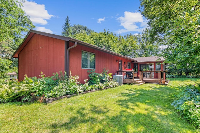 6670 Maple Dr, Rockford, MN 55373 - back of house featuring a wooden deck and a lawn