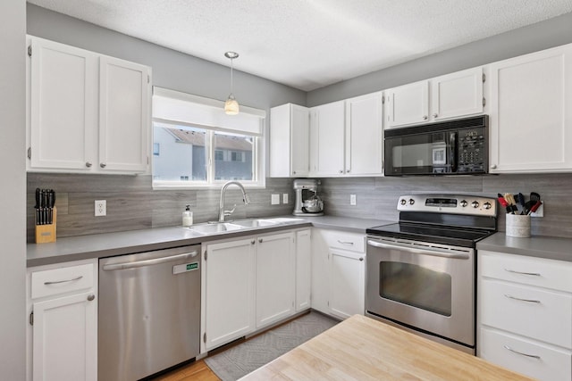 13066 Crimson Clover Ln, Eden Prairie, MN 55347 - kitchen with stainless steel appliances, tasteful backsplash, white cabinets, and a textured ceiling