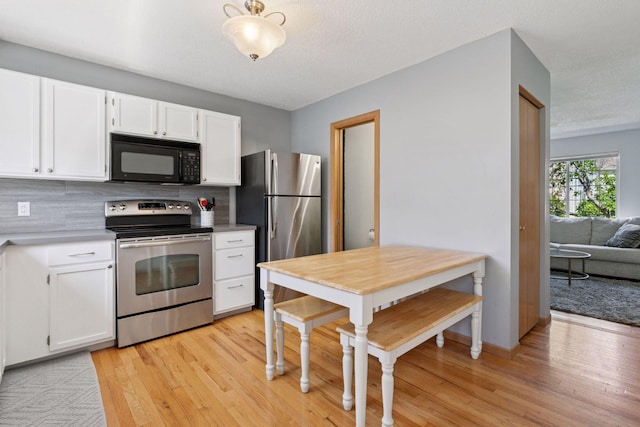 13066 Crimson Clover Ln, Eden Prairie, MN 55347 - kitchen with stainless steel appliances, light wood-style flooring, and white cabinetry