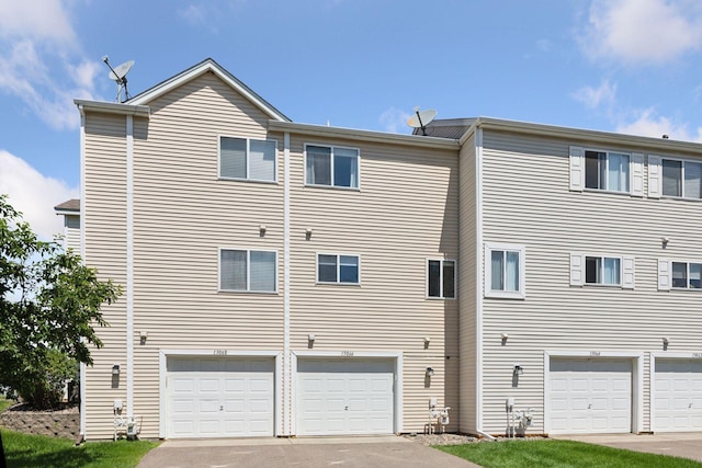 13066 Crimson Clover Ln, Eden Prairie, MN 55347 - rear view of house featuring an attached garage and driveway