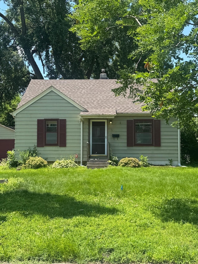 5725 Adair Ave N, Crystal, MN 55429 - ranch-style home with roof with shingles, entry steps, a chimney, and a front yard