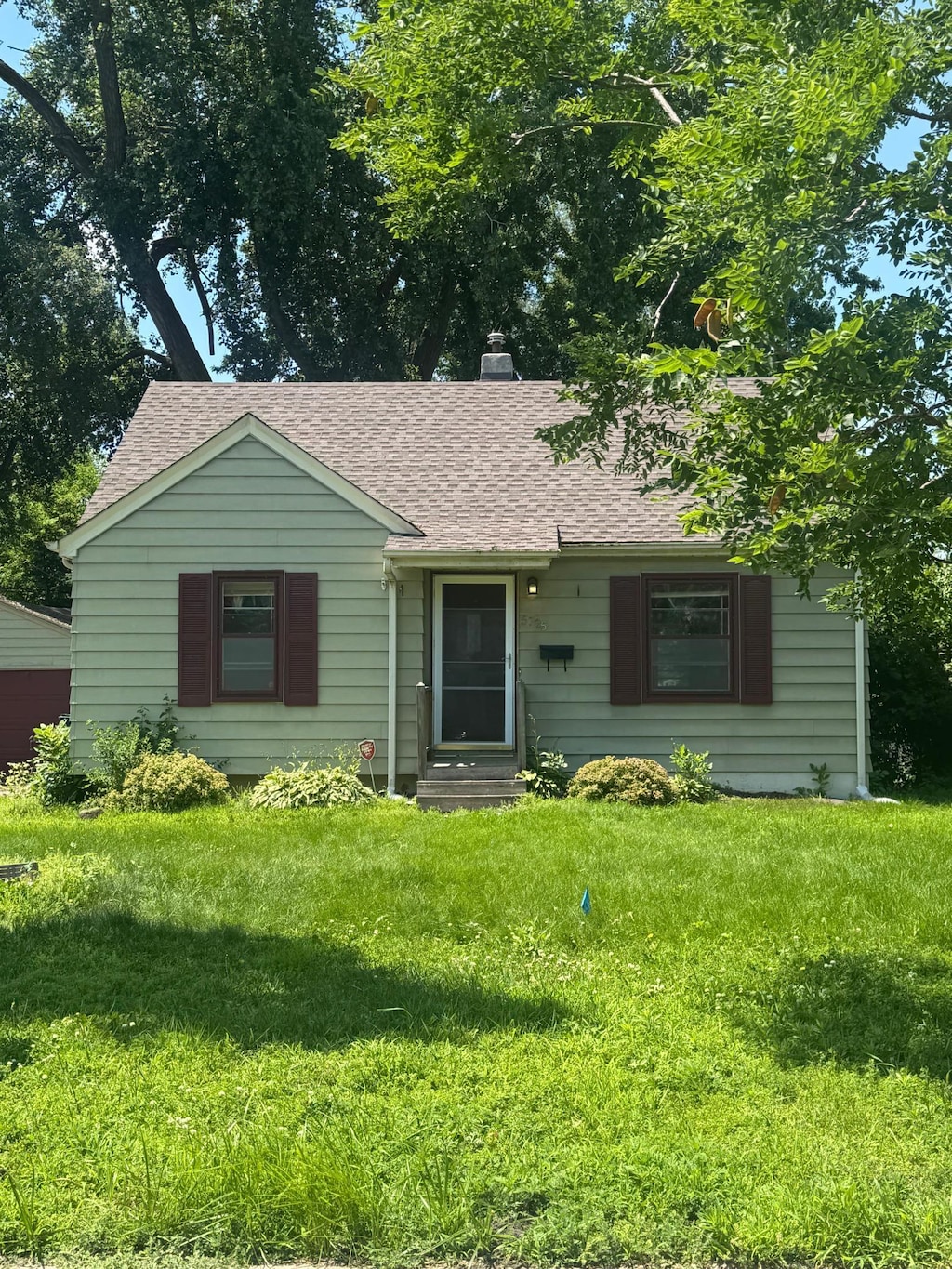 5725 Adair Ave N, Crystal, MN 55429 - single story home with a shingled roof, entry steps, a chimney, and a front lawn