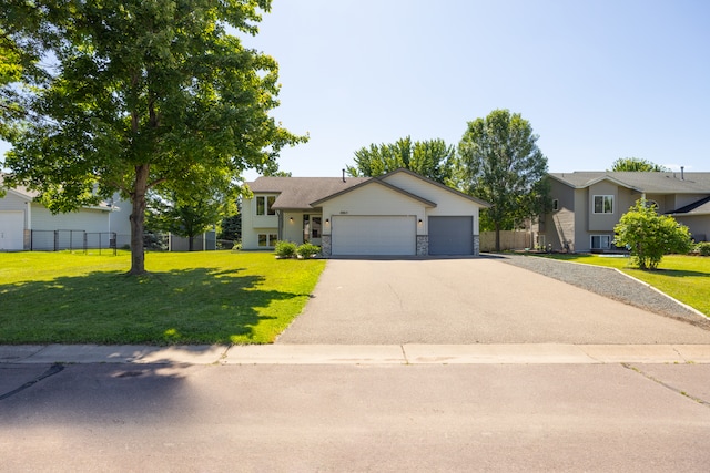 10815 Matthew Dr, Chisago City, MN 55013 - tri-level home featuring driveway, an attached garage, and stone siding