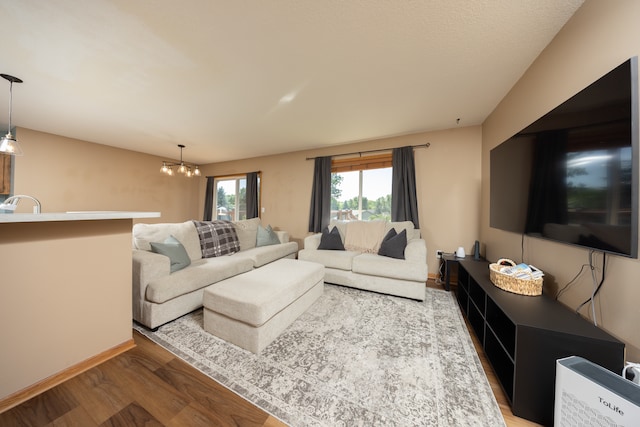 10815 Matthew Dr, Chisago City, MN 55013 - living room featuring wood finished floors and a chandelier