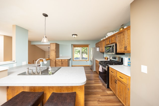 10815 Matthew Dr, Chisago City, MN 55013 - kitchen featuring stainless steel appliances, light wood-style flooring, light countertops, and a breakfast bar area
