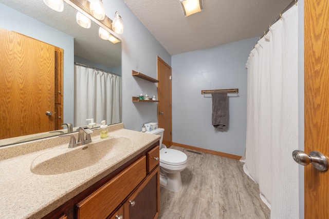 10815 Matthew Dr, Chisago City, MN 55013 - bathroom featuring wood finished floors, vanity, a textured ceiling, and a shower with curtain