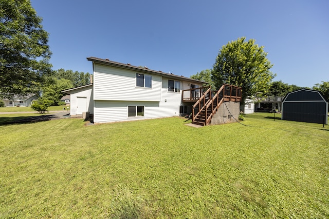 10815 Matthew Dr, Chisago City, MN 55013 - back of house featuring stairs, a wooden deck, a lawn, and a storage unit