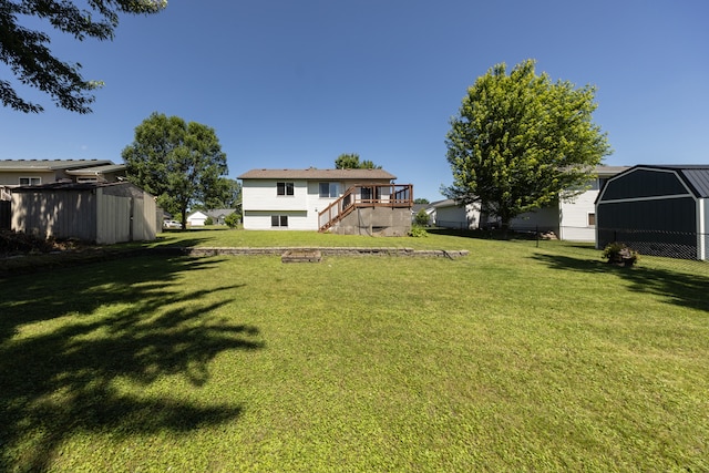 10815 Matthew Dr, Chisago City, MN 55013 - view of grassy yard with stairway, a deck, and an outdoor structure