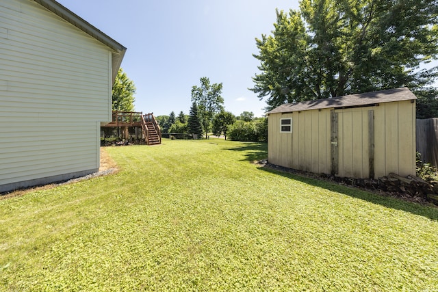 10815 Matthew Dr, Chisago City, MN 55013 - view of grassy yard with stairs, a storage unit, and a deck