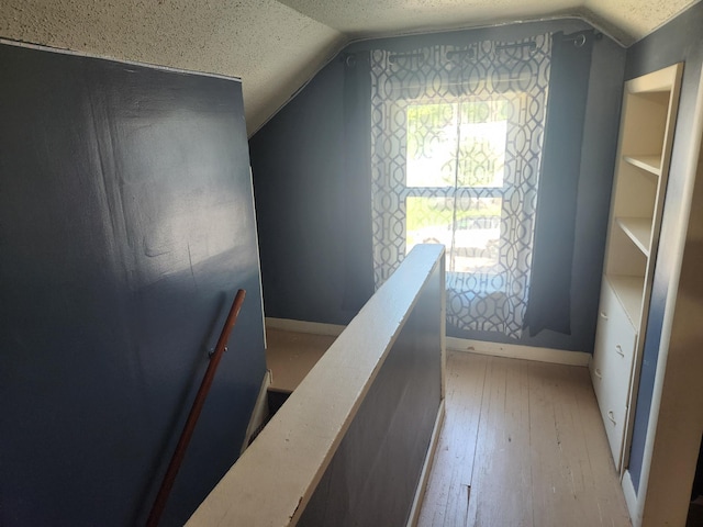 1302 Clark St, Albert Lea, MN 56007 - stairs with lofted ceiling, hardwood / wood-style flooring, and a textured ceiling