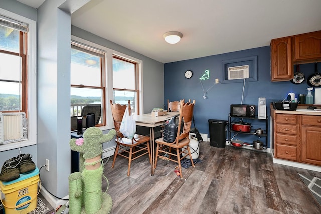 108 Hill St, Fountain City, WI 54629 - dining area featuring dark wood finished floors, a desk, and an AC wall unit
