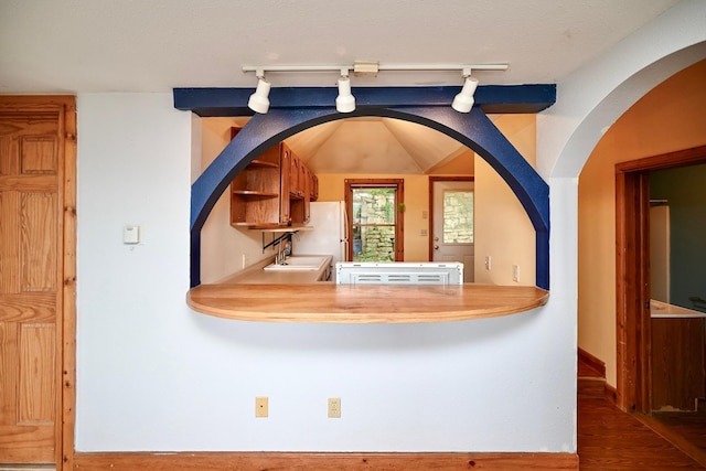 108 Hill St, Fountain City, WI 54629 - detailed view of rail lighting, wood finished floors, and freestanding refrigerator