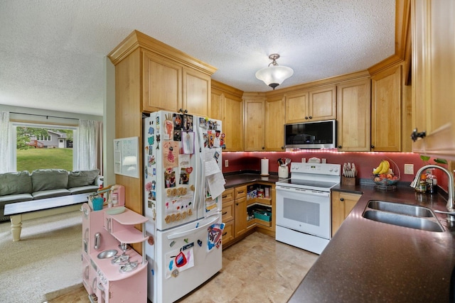 1902 3rd Ave, Grand Rapids, MN 55744 - kitchen with white appliances, a textured ceiling, dark countertops, and open floor plan