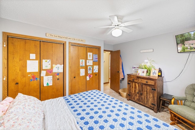 1902 3rd Ave, Grand Rapids, MN 55744 - bedroom featuring multiple closets, light carpet, ceiling fan, and a textured ceiling
