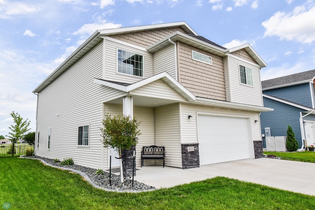 412 Hampton Dr W, Moorhead, MN 56560 - view of front of property featuring an attached garage, driveway, and stone siding