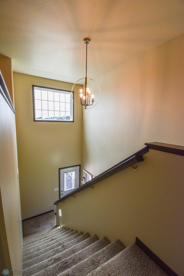 412 Hampton Dr W, Moorhead, MN 56560 - stairs with a chandelier and carpet floors