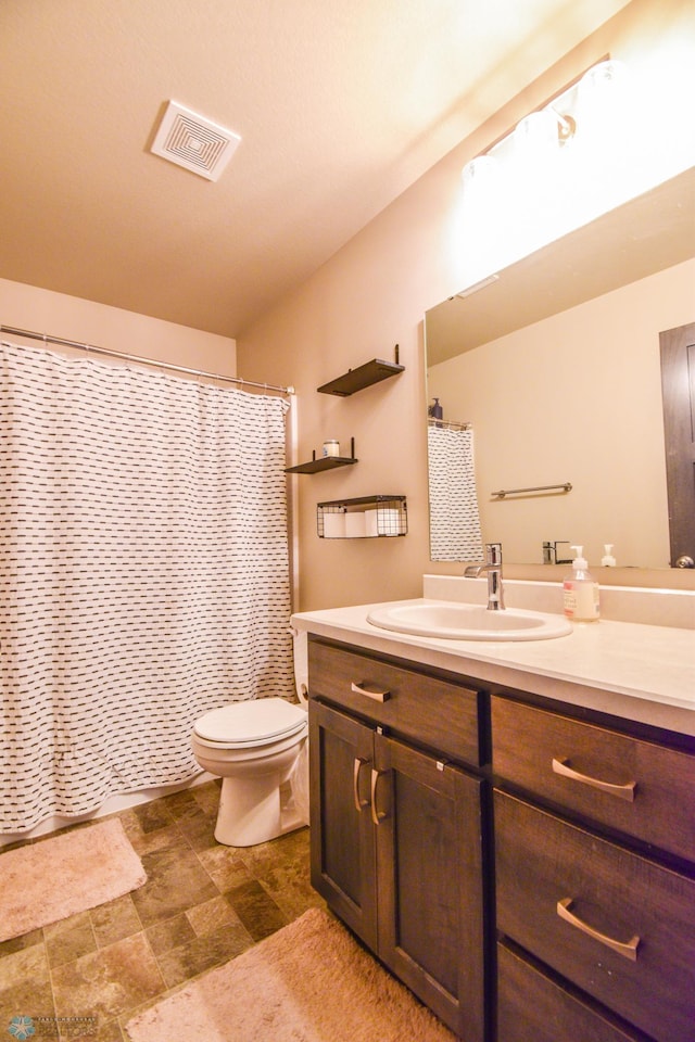 412 Hampton Dr W, Moorhead, MN 56560 - full bathroom with vanity, curtained shower, and stone finish flooring