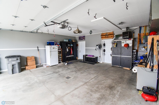 412 Hampton Dr W, Moorhead, MN 56560 - garage with freestanding refrigerator and a garage door opener
