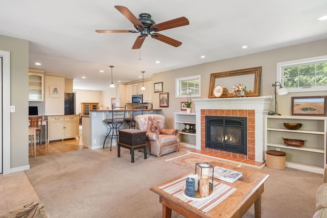 56668 145th Ave, West Concord, MN 55985 - living room with light carpet, recessed lighting, a tiled fireplace, and ceiling fan