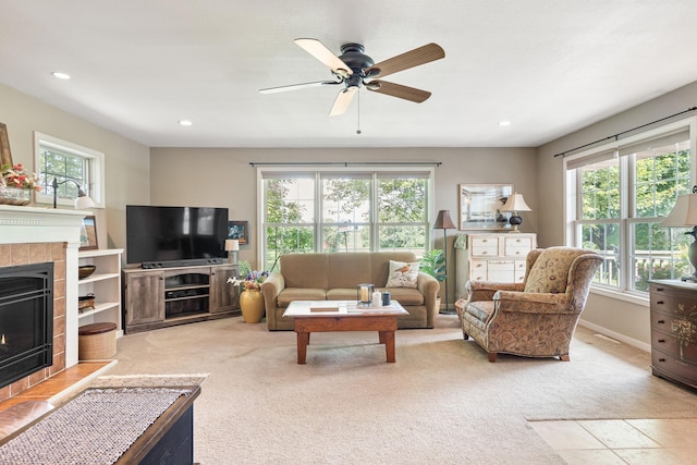 56668 145th Ave, West Concord, MN 55985 - living room with plenty of natural light, light carpet, a ceiling fan, a tiled fireplace, and recessed lighting