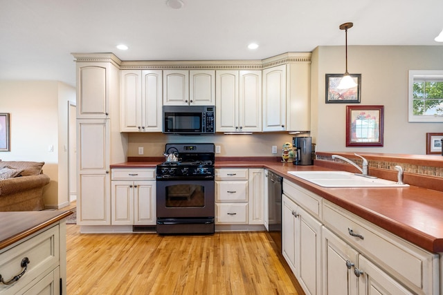 56668 145th Ave, West Concord, MN 55985 - kitchen with black appliances, decorative light fixtures, light wood finished floors, recessed lighting, and cream cabinets