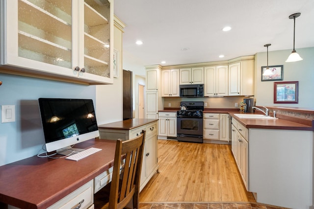 56668 145th Ave, West Concord, MN 55985 - kitchen featuring black appliances, cream cabinets, dark countertops, glass insert cabinets, and pendant lighting