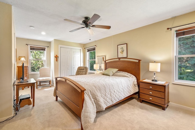 56668 145th Ave, West Concord, MN 55985 - bedroom with light carpet, a closet, and a ceiling fan
