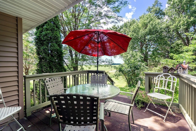 56668 145th Ave, West Concord, MN 55985 - wooden deck featuring outdoor dining space and view of scattered trees
