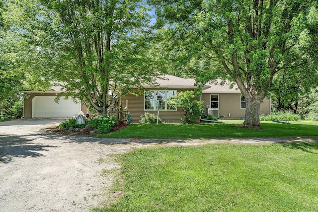 56668 145th Ave, West Concord, MN 55985 - obstructed view of property with driveway, a garage, and a front yard