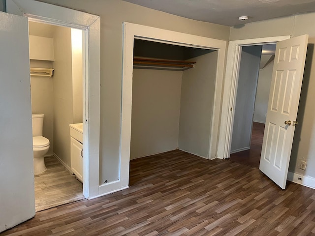 1026 Fremont Ave, Saint Paul, MN 55106 - unfurnished bedroom featuring dark wood-style flooring, a closet, and connected bathroom