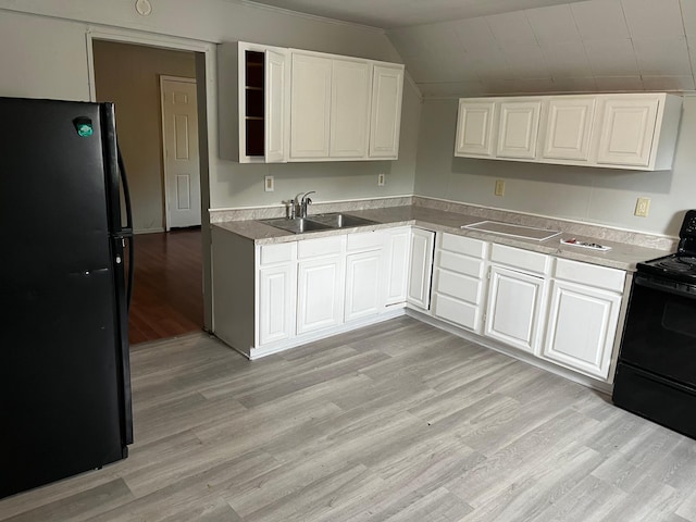 1026 Fremont Ave, Saint Paul, MN 55106 - kitchen featuring black appliances, light wood-type flooring, white cabinets, and lofted ceiling