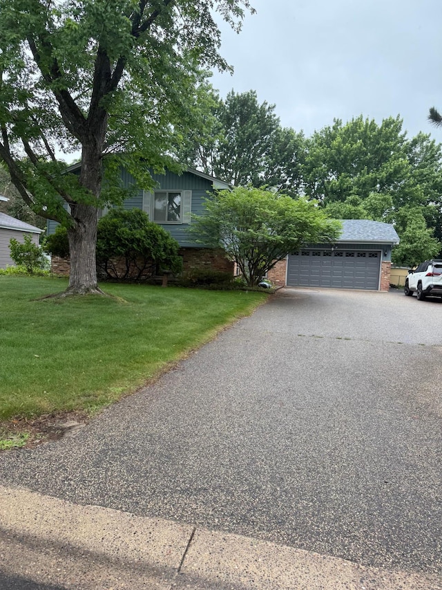 8025 Orchard Ave N, Brooklyn Park, MN 55443 - view of front facade featuring brick siding, a front yard, and driveway