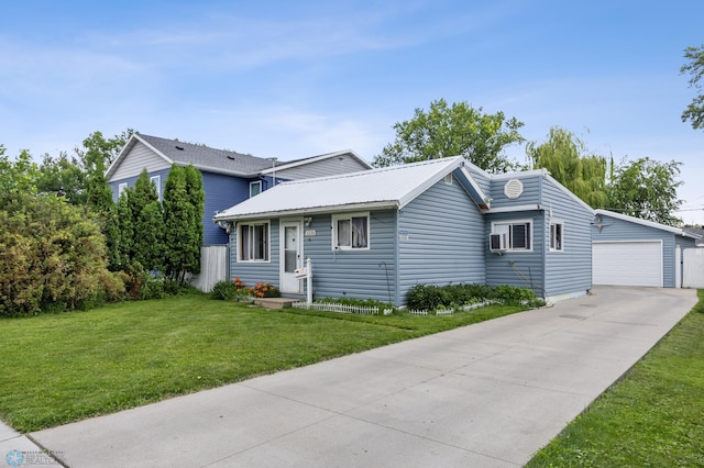 1330 16 1/2 St S, Fargo, ND 58103 - view of front of home featuring a front yard, a detached garage, and an outbuilding