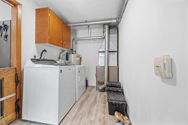 1330 16 1/2 St S, Fargo, ND 58103 - laundry room featuring cabinet space, washing machine and dryer, light wood-style flooring, heating unit, and gas water heater