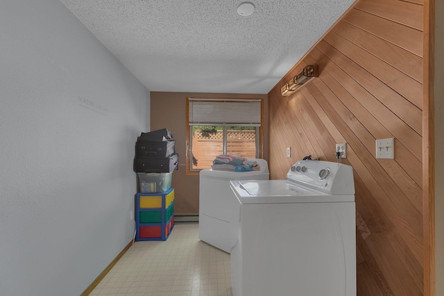 302 3rd Ave N, Bowlus, MN 56314 - laundry area featuring washer and dryer, a textured ceiling, and wood walls