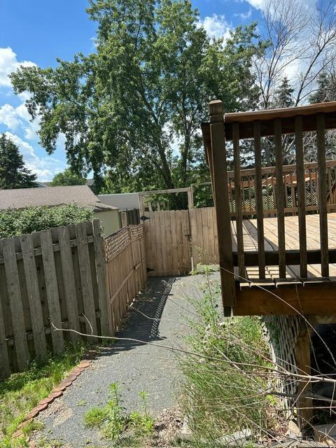 3324 131st Ln NW, Coon Rapids, MN 55448 - view of yard with a wooden deck and a gate