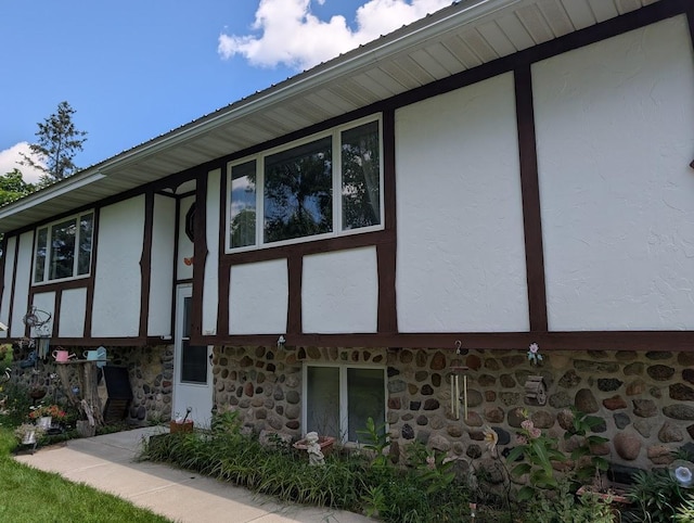 670 23rd Ave NE, Sauk Rapids, MN 56379 - view of home's exterior featuring stucco siding and stone siding