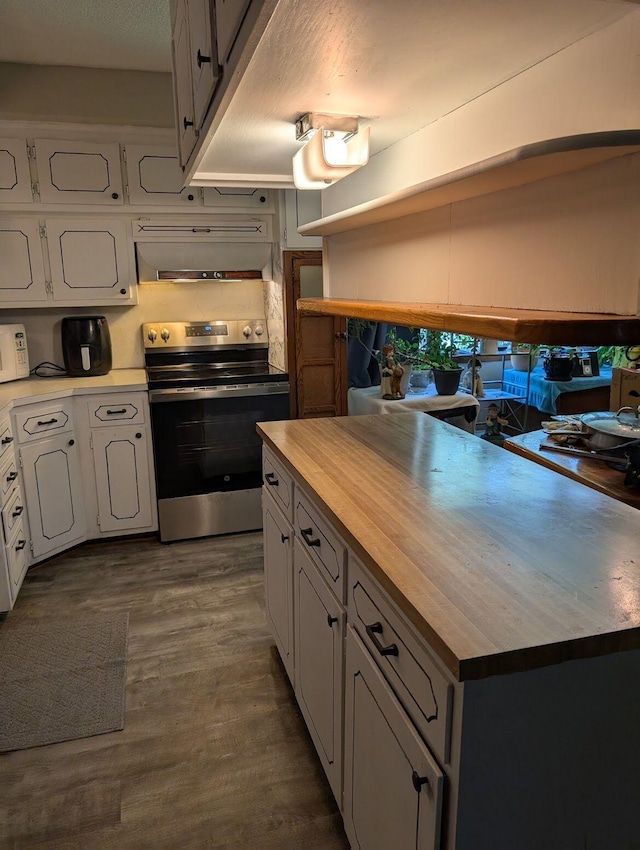 670 23rd Ave NE, Sauk Rapids, MN 56379 - kitchen with electric stove, butcher block counters, dark wood-type flooring, and white cabinetry